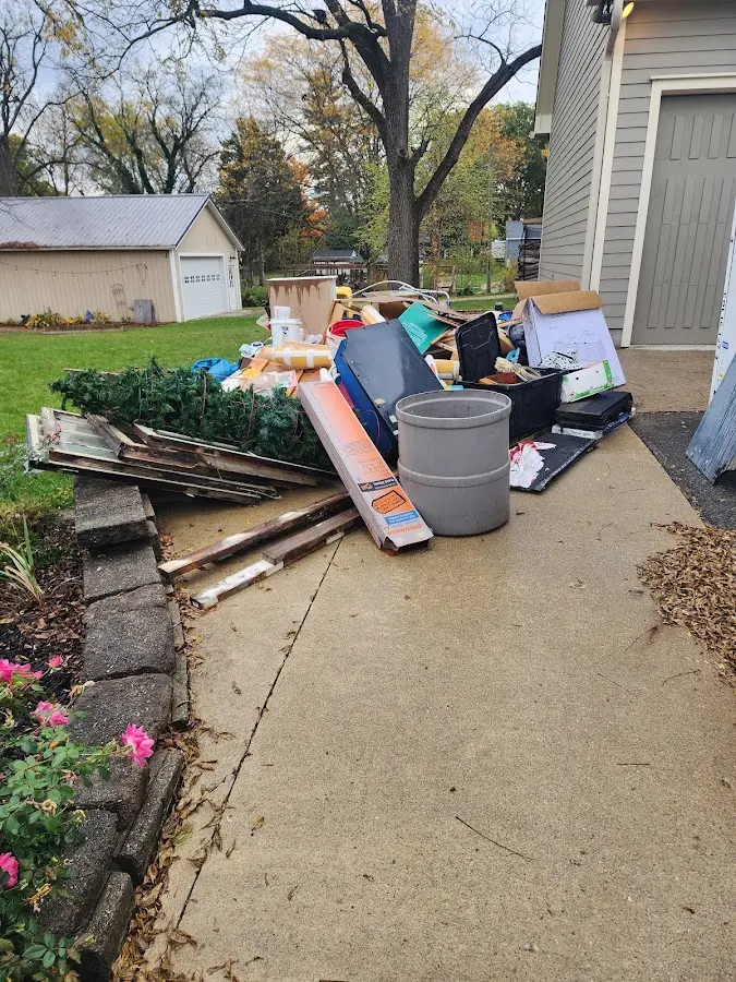 Dumpster being loaded with debris for Residential Dumpster Rental in Hokes Bluff